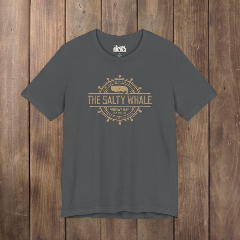 Asphalt gray The Salty Whale vintage distressed pub logo t-shirt inspired by Widow's Bay Apple TV series, soft Bella+Canvas cotton tee