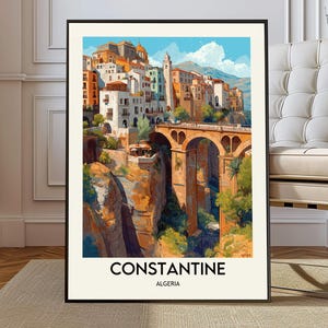 May include: A framed art print of Constantine, Algeria. The artwork depicts a vibrant cityscape with buildings perched on a cliffside, connected by a bridge. The color palette includes warm tones of orange, beige, and brown, contrasted by a blue sky. The text "CONSTANTINE ALGERIA" is at the bottom.
