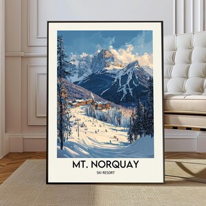 May include: A framed print of Mt. Norquay Ski Resort. The artwork depicts a snowy mountain scene with skiers, trees, and buildings. The sky is blue with white clouds. The text "MT. NORQUAY SKI RESORT" is at the bottom.