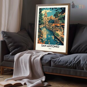 May include: A vintage travel poster featuring a colorful illustration of the San Antonio River Walk in Texas. The poster features a river with boats, buildings, and people walking along the riverbank. The text "San Antonio, Texas" is printed at the bottom of the poster.