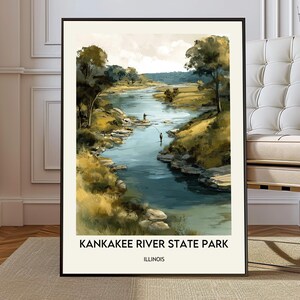 May include: Framed art print of Kankakee River State Park in Illinois. The artwork depicts a river scene with trees, grassy banks, and two figures fishing. The print has a black frame and the text "KANKAKEE RIVER STATE PARK ILLINOIS" at the bottom.