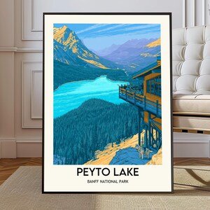 May include: A framed art print of Peyto Lake in Banff National Park. The illustration features a turquoise lake surrounded by mountains and evergreen trees. A building with a viewing platform overlooks the lake. The text "PEYTO LAKE" and "BANFF NATIONAL PARK" are at the bottom.