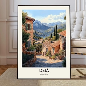 May include: Framed print of a European village scene. The artwork depicts stone buildings with red tile roofs, green shutters, and lush greenery. The text "DEIÀ MALLORCA" is printed at the bottom of the image. A mountain range is visible in the background under a blue sky.