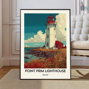 May include: A framed art print of Point Prim Lighthouse in Belfast. The lighthouse is white with a red top and sits on a rocky shore with red and yellow grasses. The sky is blue with white clouds. The print has the text "POINT PRIM LIGHTHOUSE BELFAST".