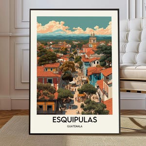May include: A framed art print of Esquipulas, Guatemala, featuring a vibrant cityscape with red-tiled roofs, colorful buildings, and a prominent church tower. The artwork showcases a detailed illustration style with a warm color palette, capturing the essence of the town.