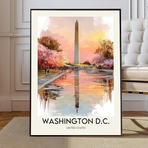 May include: Framed art print featuring the Washington Monument reflected in a body of water, with cherry blossoms and a sunset sky. The text "WASHINGTON D.C. UNITED STATES" is at the bottom of the print. The artwork is in a black frame.