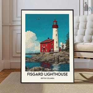 May include: A framed art print of Fisgard Lighthouse in British Columbia. The artwork depicts a white lighthouse with a red top and a red building, set against a blue sky and ocean. The print includes the text "FISGARD LIGHTHOUSE" and "BRITISH COLUMBIA".