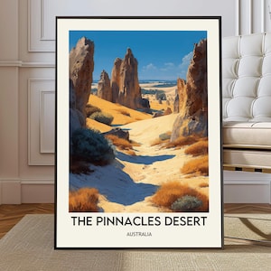 May include: A framed art print featuring a desert landscape with tall rock formations under a bright blue sky. The print includes the text "THE PINNACLES DESERT AUSTRALIA" at the bottom. The artwork is displayed in a black frame.