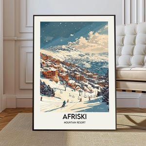 May include: A framed art print featuring a winter landscape of Afriski Mountain Resort. The artwork depicts skiers, snow-covered mountains, and buildings. The text "AFRISKI MOUNTAIN RESORT" is at the bottom of the print.