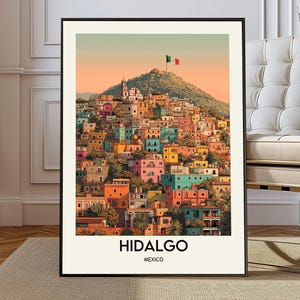 May include: A framed art print featuring a colorful illustration of Hidalgo, Mexico. The artwork depicts a hillside town with vibrant buildings in shades of orange, blue, and pink. The Mexican flag waves atop a mountain, with the text "Hidalgo Mexico" at the bottom.