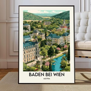 May include: A framed art print of Baden bei Wien, Austria. The illustration depicts a scenic view of the town with buildings, trees, and a river. The print has a black frame and the text "BADEN BEI WIEN AUSTRIA" at the bottom.