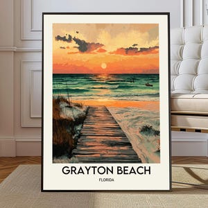 May include: Framed art print of a beach scene at sunset. A wooden boardwalk leads to the ocean, under an orange and yellow sky. The text "GRAYTON BEACH FLORIDA" is printed at the bottom of the print. The artwork evokes a sense of calm.