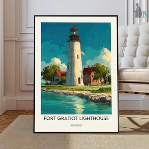 May include: A framed art print of the Fort Gratiot Lighthouse in Michigan. The artwork depicts a tall, white lighthouse with a red-roofed building nearby, set against a blue sky and turquoise water. The text "FORT GRATIOT LIGHTHOUSE MICHIGAN" is at the bottom.