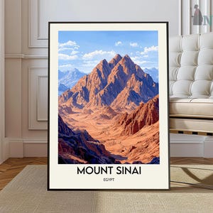 May include: A framed art print featuring a vibrant landscape of Mount Sinai in Egypt. The artwork showcases the mountain's rugged, reddish-brown peaks under a bright blue sky with fluffy clouds. The text "MOUNT SINAI EGYPT" is printed at the bottom.