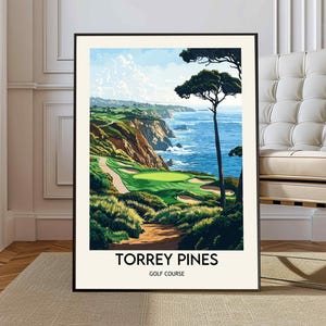 May include: A framed art print of Torrey Pines Golf Course. The artwork depicts a scenic view of the golf course with a green fairway, ocean, and cliffs. The print has a black frame and the words "Torrey Pines Golf Course" are printed at the bottom.