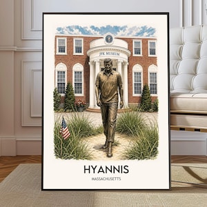 May include: A framed wall art print featuring a bronze-colored statue of John F. Kennedy walking in front of the JFK Museum building. The scene includes green grass, a small American flag, and the text HYANNIS MASSACHUSETTS at the bottom.