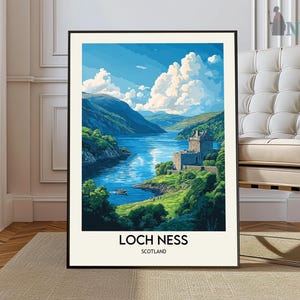 May include: A framed print of a painting depicting a view of Loch Ness in Scotland. The painting shows a blue lake with a green hillside and a castle in the distance. The text "Loch Ness" and "Scotland" is printed below the image.