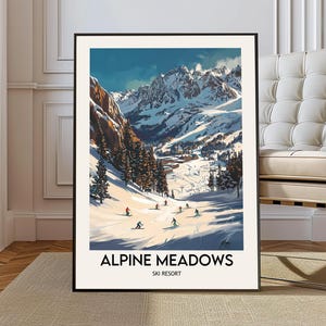 May include: A framed art print featuring a winter landscape with skiers on a snowy slope. The artwork depicts a mountain range under a blue sky, with the words "Alpine Meadows Ski Resort" at the bottom.