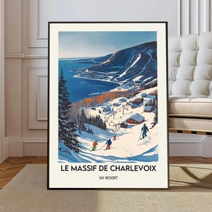 May include: A framed art print of a winter landscape featuring a ski resort. The artwork depicts skiers on a snowy slope, with a town and a body of water in the background. The text "LE MASSIF DE CHARLEVOIX SKI RESORT" is at the bottom.