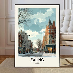 May include: A framed art print featuring a street scene in Ealing, London. The artwork depicts a snowy street with buildings in shades of red, white, and gray. The sky is a mix of blue and white. The word "EALING" and "LONDON" are printed at the bottom.