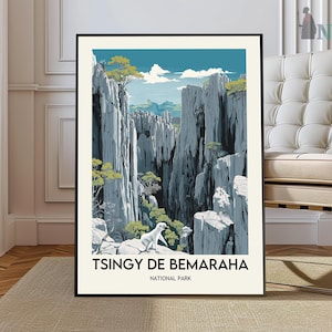 May include: A framed art print showing a stylized landscape of Tsingy de Bemaraha National Park. The artwork depicts towering grey rock formations, green trees, and a white dog. The text "TSINGY DE BEMARAHA NATIONAL PARK" is printed at the bottom.