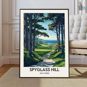 May include: A framed art print of Spyglass Hill Golf Course. The artwork depicts a scenic golf course with a pathway leading to a green, with trees and ocean views. The print has a black frame and the text "SPYGLASS HILL GOLF COURSE".