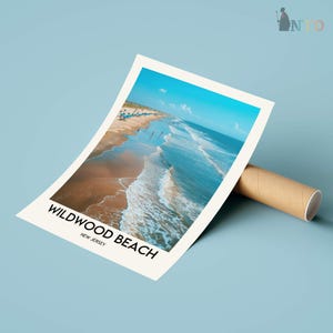 May include: A poster print of Wildwood Beach, New Jersey, showing a beach scene with blue ocean waves and a sandy shore under a clear sky. The poster is propped up by a brown cardboard tube. Text on the poster reads "Wildwood Beach, New Jersey."