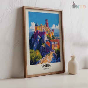 May include: A framed print of a colorful illustration of Pena National Palace in Sintra, Portugal. The palace is perched on a rocky hilltop with a winding path leading up to it. The text "SINTRA PORTUGAL" is printed below the image.