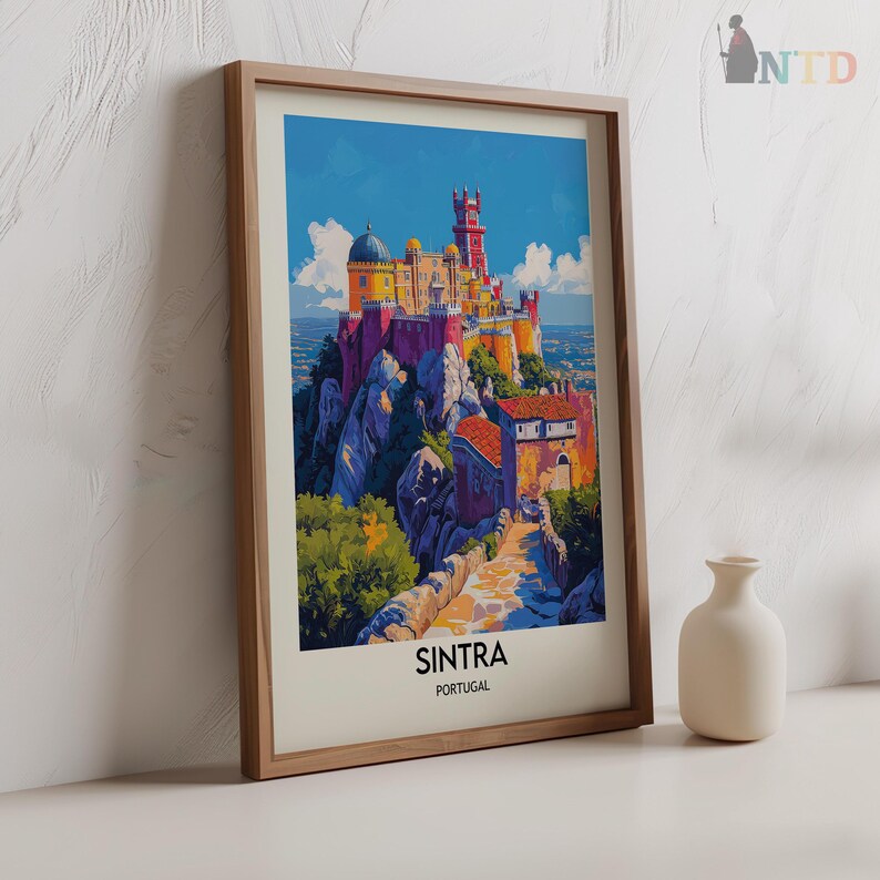 May include: A framed print of a colorful illustration of Pena National Palace in Sintra, Portugal. The palace is perched on a rocky hilltop with a winding path leading up to it. The text "SINTRA PORTUGAL" is printed below the image.