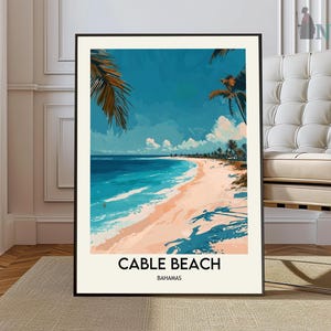 May include: A poster with a blue and white image of a beach with palm trees and the text "Cable Beach Bahamas".