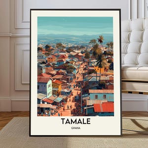 May include: A framed art print of Tamale, Ghana, featuring a colorful illustration of a bustling cityscape. The artwork showcases buildings with red, orange, and blue roofs, palm trees, and a distant mountain range under a clear blue sky. The text "TAMALE GHANA" is at the bottom.