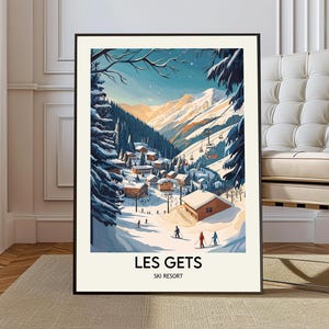 May include: A framed print of a winter ski resort scene. The artwork depicts a snow-covered village nestled in a valley, with skiers, a ski lift, and snow-covered mountains in the background. The text "LES GETS SKI RESORT" is at the bottom.