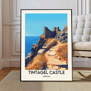 May include: A vintage travel poster featuring a scenic view of Tintagel Castle in Cornwall, England. The poster is illustrated with a stone pathway leading up to the castle ruins, set against a backdrop of a blue ocean and a bright blue sky.