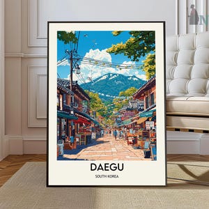 May include: A colorful illustration of a street scene in Daegu, South Korea. The image features a narrow street lined with shops and buildings, with a mountain in the background. The sky is blue with white clouds. The text "DAEGU" and "SOUTH KOREA" is printed at the bottom of the image.