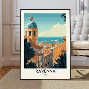 May include: A framed art print featuring a stylized illustration of Ravenna, Italy. The artwork depicts a cityscape with a blue-domed building, terracotta rooftops, and the sea in the background. The word "RAVENNA" is printed at the bottom.