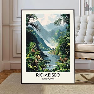 May include: A framed art print featuring a vibrant landscape of Rio Abiseo National Park. The artwork depicts a river winding through a lush, green valley with mountains in the background. The text "RIO ABISEO NATIONAL PARK" is printed at the bottom.