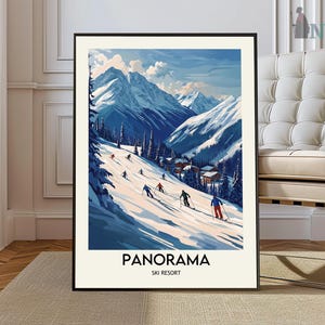 May include: A framed art print featuring a winter ski resort scene. The artwork depicts skiers on a snowy slope with towering mountains in the background. The print has a black frame and the words "PANORAMA SKI RESORT" at the bottom.