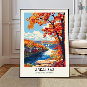 May include: A vintage travel poster featuring a scenic view of a river winding through a forest with vibrant fall foliage. The poster is framed in black and has the text "Arkansas, United States of America" at the bottom.