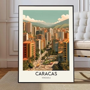 May include: A framed art print of Caracas, Venezuela. The illustration depicts a cityscape with colorful buildings, palm trees, and mountains in the background. The text "CARACAS" and "VENEZUELA" are at the bottom of the print.