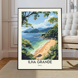 May include: A framed art print of Ilha Grande, Brazil, showing a beach scene. The artwork depicts a sandy beach, turquoise water, lush green vegetation, and distant mountains under a bright blue sky. The print includes the text "ILHA GRANDE BRAZIL".