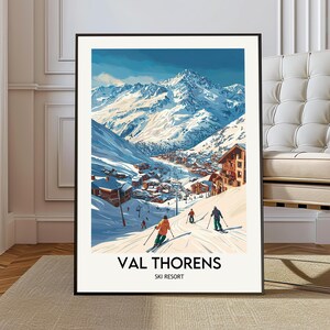 May include: A framed print of a vintage travel poster for Val Thorens Ski Resort. The artwork shows a snowy mountain landscape with skiers, chalets, and the resort's name in bold letters. The colour palette includes blues, whites, and oranges.