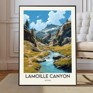May include: A framed art print featuring a scenic view of Lamoille Canyon in Nevada. The artwork depicts a river flowing through a valley with mountains in the background under a blue sky with clouds. The text "Lamoille Canyon Nevada" is at the bottom.