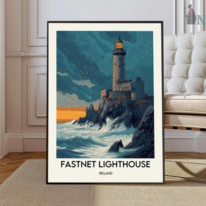 May include: Framed art print of Fastnet Lighthouse in Ireland. The artwork depicts a tall, stone lighthouse on a rocky cliff, with crashing waves and a dramatic sky. The text "FASTNET LIGHTHOUSE IRELAND" is at the bottom.