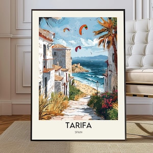 May include: A framed art print of Tarifa, Spain, showing white buildings with red-tiled roofs, a beach, and the sea under a blue sky with kites. The text "Tarifa Spain" is at the bottom of the print.