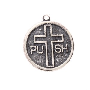 May include: Silver charm with a cross and the words "PUSH" on a round disc.