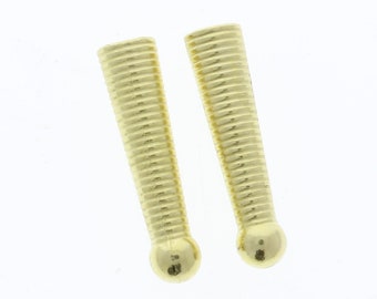 May include: Two gold-colored metal knobs with a ribbed design and a rounded top.