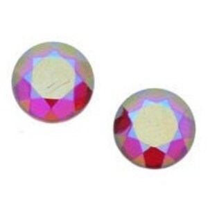 May include: Two iridescent pink and purple round glass rhinestones.