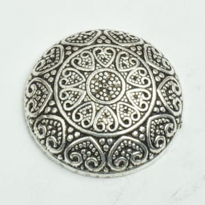 May include: A silver-toned metal button with a decorative design of intricate swirls and hearts.