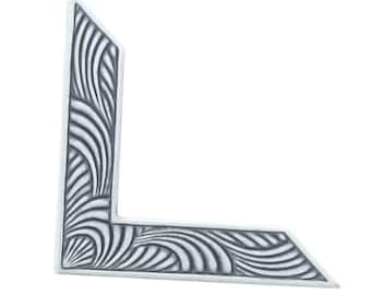 May include: A silver corner piece with a decorative design of curved lines.