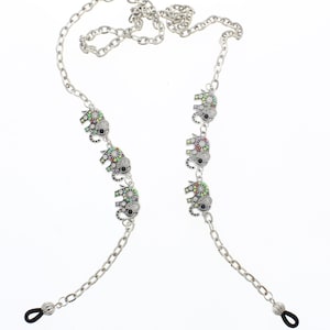 May include: Silver chain with colorful elephant charms, designed to hold glasses. The chain has black rubber ends for a secure fit.